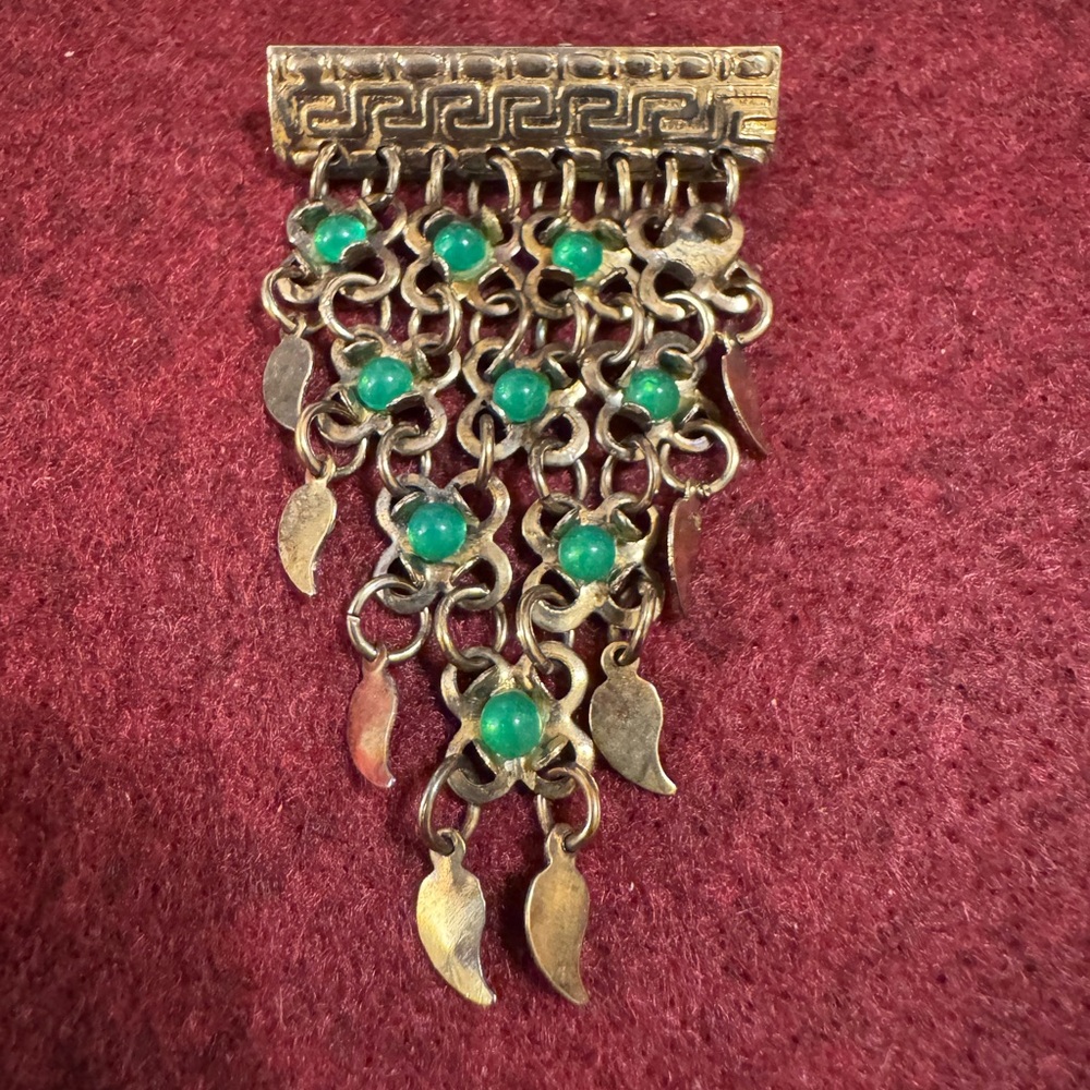 Vintage Greek style articulated brooch with green beads and gold finish links